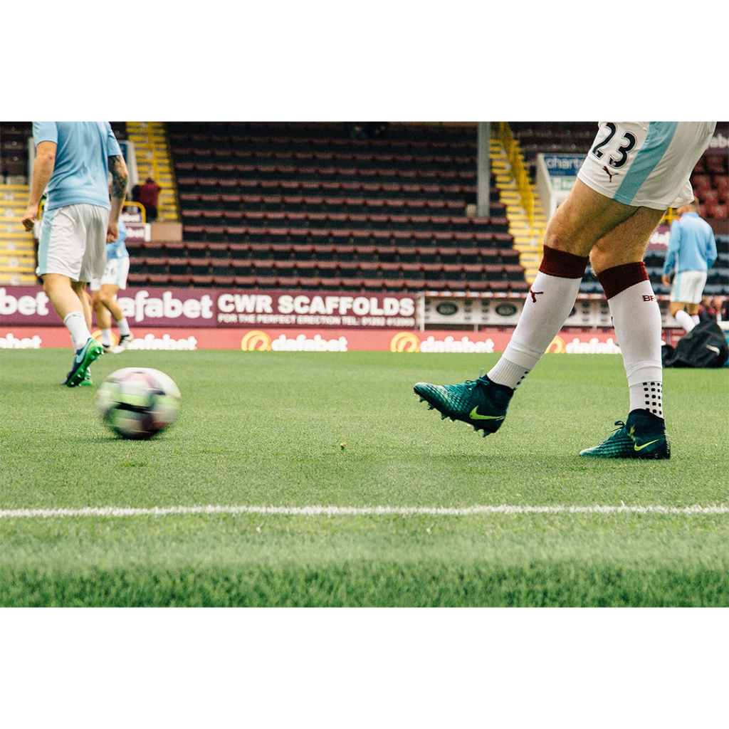 Player kicking a football (Top Sports Ticketing Companies)