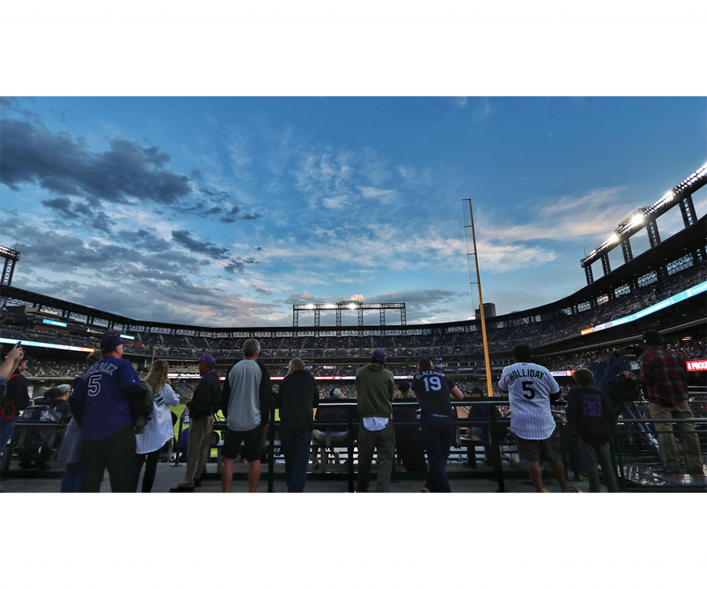 baseball fans in stadium at dusk